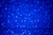 Blue round bokeh Background with Bright glitter Lights for Valentine`s Day or Women day. Defocused shine texture for greeting card