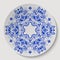 Blue round floral ornament. Pattern applied to the ceramic plate