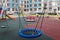 Blue round wicker swing children playground residential community residential buildings exterior background