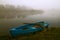 Blue rowboat in the fog