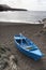 Blue rowing boat on the beach