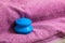 Blue rubber cupping glass on pink towel for vacuum massage
