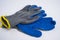 blue rubberized work gloves lie on a white background. construction and repair