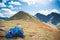 Blue Rucksack and mountain path in the background - trekking equipment, hillwalking gear, mountaineering