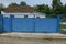 Blue rural metal gate and part of the fence in the street