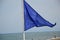 Blue safety flag on the beach from the Mediterranean sea