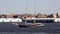 Blue sail tour boat CLIPPER CITY, passing on background of Red Hook docks on Brooklyn side, New York, NY