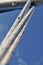 Blue sailing ropes with white yacht sail in the background