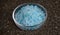 Blue Salt in Petri Dish on Ruberoid Grain Surface