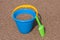 Blue Sand Bucket & Green shovel on the beach