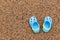 Blue sandals slipper on the sand