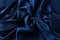 Blue sapphire color silk fabric background, top view