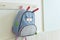 Blue school rucksack hanging on the wall