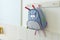 Blue school rucksack hanging on the wall