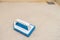 Blue scrub brush on the bathroom floor