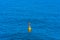 Blue sea background with yellow buoy, regular structure in bright shades of blue, Albania