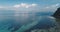 Blue sea bay at sand beach aerial. Shallow clear ocean water with reefs. Amazing serene seascape