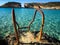 Blue sea of blue lagoon, with an ancient metal staircase for bathers and small islands in the background