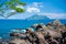 Blue sea and blue sky with changing white clouds. Small islands and rocks.