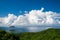 The blue sea, the blue sky, and the dynamic white clouds.