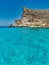 Blue sea and blue sky rocks lampedusa rabbits beach sicily italy meditherranean sea