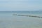 Blue sea with boat and wooden pier landscape. Romantic seaside view toned photo