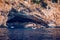 Blue sea and the characteristic caves of Cala Luna, a beach in the Golfo di Orosei, Sardinia, Italy. Big sea caves in the