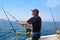 Blue sea fisherman in trolling boat with downrigger