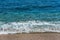 Blue sea and golden pebbles in Sardinia