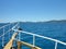 Blue sea and green island, view from the deck of yacht