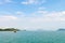 Blue sea lagoon with limestone green islands, cloudy sky and a w