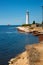 Blue sea lanscape with white lighthouse on foreland