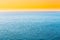 Blue Sea Or Ocean And Yellow Clear Sunset Or Sunrise Sky Background