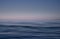 Blue sea and pink sky background. Waves shot at long exposure