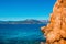 Blue sea and red rocks in Rocce Rosse beach in Sardinia