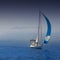 Blue sea with sailboat sailing in a foggy coast