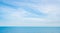 Blue sea on sunny, cloudy sky background