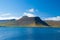 Blue sea water on mountain landscape in isafjordur, iceland. Hilly coastline on sunny blue sky. Summer vacation on