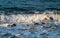 Blue sea water tide closeup photo. Relaxing sea wave surf over seashore.