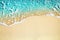 Blue sea wave, white foam, golden sand beach, turquoise ocean water close up, summer holidays border frame concept, copy space