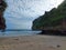 Blue sea white sand beach with beautiful towering hills and rocks