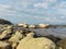 Blue seascape with many stones on a sunny day