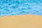 Blue seaside water on light yellow beach sand coastline seashore background