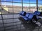Blue seats against the background of the runway outside the window in the departure area of