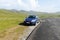 Blue sedan car on mountain plateau