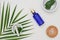Blue serum bottle with martar, massage salt, herb on white background. Spa and beauty organic concept