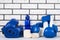 Blue set of helmet and boxing gloves for sports on a brick wall background