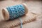 blue sewing thread spool bobbin on wooden table backg