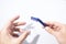 Blue shaving razor and a hand isolated in a white background