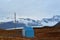 A blue shed surrounded by glaciel ice